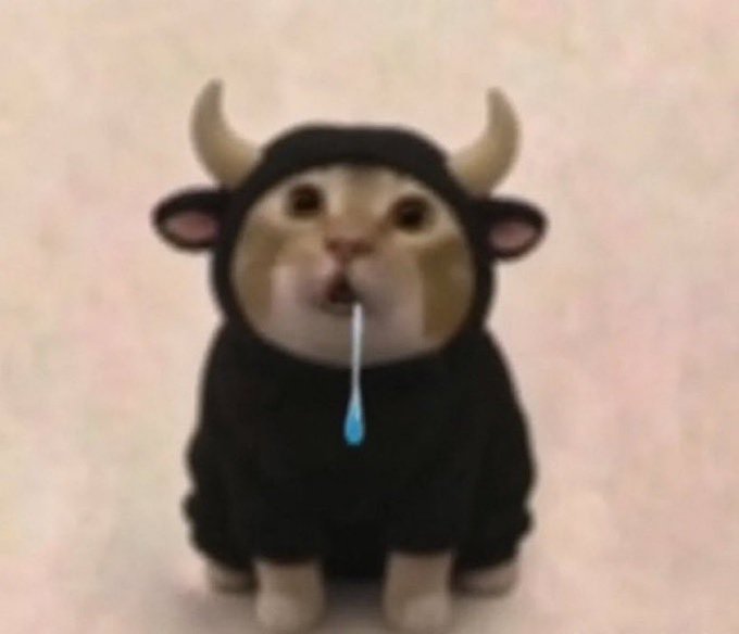 A small cat wearing a black bull costume with horns, drooling with a visible line of saliva as a comical visual pun on the "$drooling cat" reference, paired with the playful suggestion to "send" the meme alongside "$Ansem" in a humorous financial context.