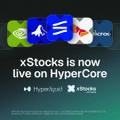 A promotional graphic for HyperCore with several stacked cryptocurrency icons (including ETH, MATIC, BTC, and others) and the text 'xStocks is now live on HyperCore' along with the Hyperliquid and xStocks logos.