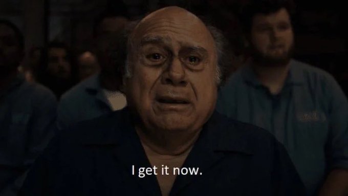 Screenshot from a movie or show featuring an older bald man in a dark shirt with a shocked or emotional expression, captioned 'I get it now.'