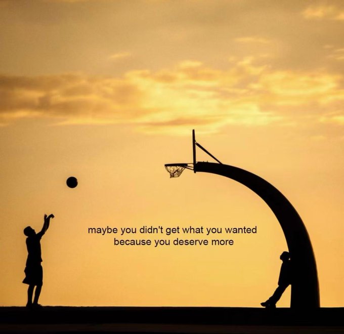 A silhouette of a person shooting a basketball toward a hoop at sunset, with the inspirational text: 'maybe you didn't get what you wanted because you deserve more'.