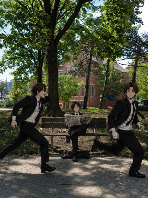 Two anime figures in black suits run past a park bench where a third suited figure calmly reads a newspaper, set against a tree-lined walkway with a brick building in the background. The image humorously contrasts the frantic pace of the running characters with the serene, unbothered reader, echoing the post's message about maintaining composure and faith ("God") amid the chaos of Web3.