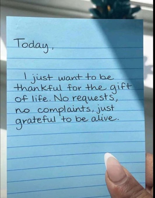 A handwritten note on blue lined paper reads: 'Today, I just want to be thankful for the gift of life. No requests, no complaints, just grateful to be alive.'