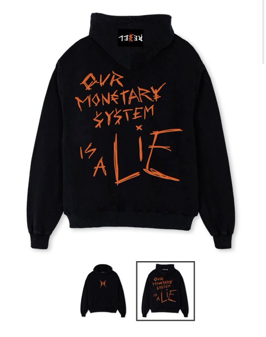A black hoodie displays the handwritten-style orange text "OUR MONETARY SYSTEM IS A LIE" on the back, with a "1-EX" brand tag visible at the neck.