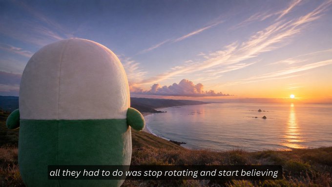 A plush toy with a white dome top and green body stands on a grassy cliff overlooking a sunset ocean view. The subtitle reads "all they had to do was stop rotating and start believing," playing on the phrase "here's your sign" to humorously suggest the plush figure itself is the sign someone needed.