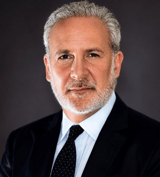 Professional headshot of a middle-aged man with gray hair and a beard, wearing a dark suit, white shirt, and dark dotted tie against a dark gray background.