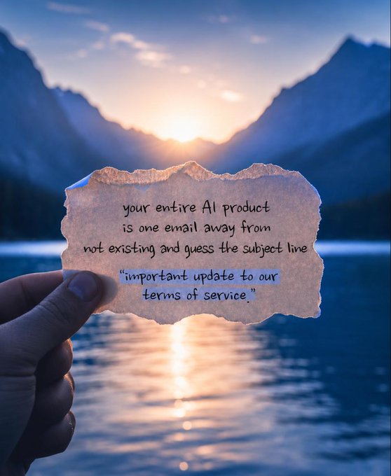 A hand holding a torn paper with text 'your entire AI product is one email away from not existing and guess the subject line: "important update to our terms of service."' against a mountain lake sunset background.