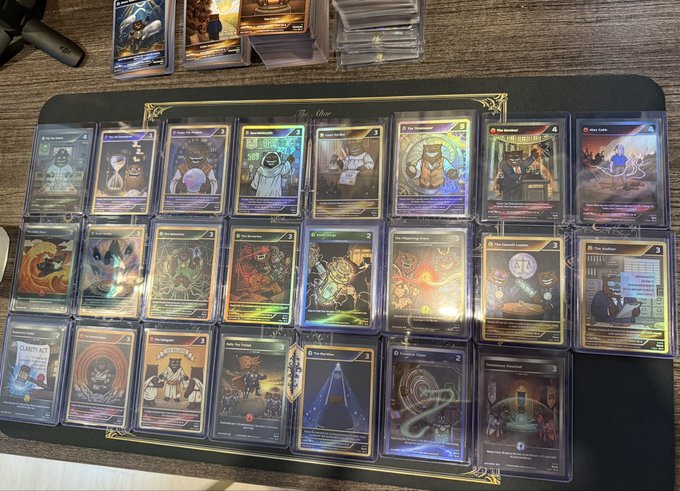 A collection of holographic trading cards is displayed on a black mat, featuring Judge Judy-themed designs with various illustrated characters and legal-themed artwork.