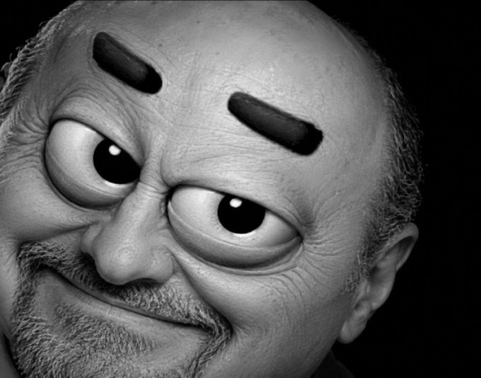 A black-and-white digitally manipulated close-up portrait of a bald man with a beard, with his eyes replaced by exaggerated cartoonish googly eyes and thick black eyebrow-shaped graphics.