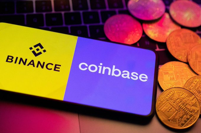 The image shows a smartphone displaying the Binance and Coinbase logos side-by-side, resting on a laptop keyboard alongside physical Bitcoin tokens. It visually represents the context of crypto funds being transferred to major exchanges, as referenced in the post about Wintermute's $57 million transfer of Bitcoin and Solana to these platforms.