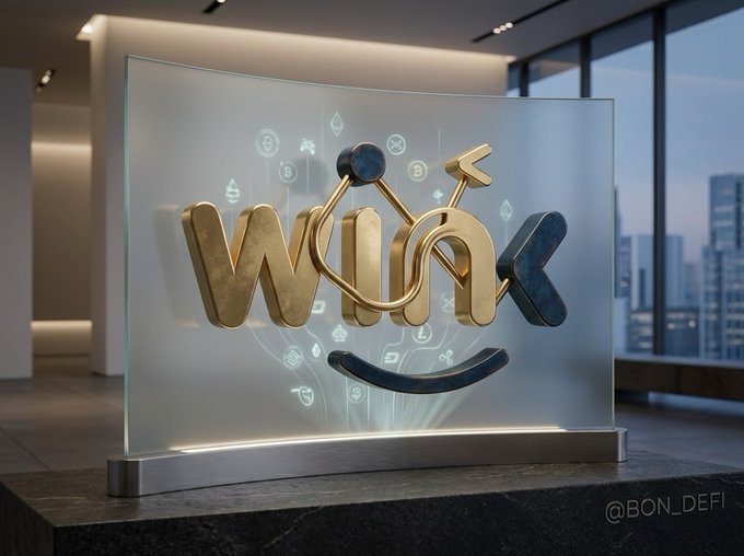 A 3D rendering of a translucent glass sign featuring a stylized 'Wink' logo in gold and dark metal with a smile beneath it, displayed in a modern office setting with city views.