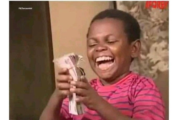 A young boy in a pink striped shirt laughs hysterically while clutching a thick stack of Nigerian Naira bills, with "FORBES" and "FB/SarcasmLol" watermarks visible.