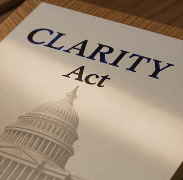 A document titled "CLARITY Act" rests on a wooden surface, with an illustration of the U.S. Capitol dome visible at the bottom. The image visually reinforces the post's breaking news about President Trump meeting with U.S. Senators to finalize the Bitcoin Clarity Act, symbolizing the legislative progress toward crypto regulatory clarity.