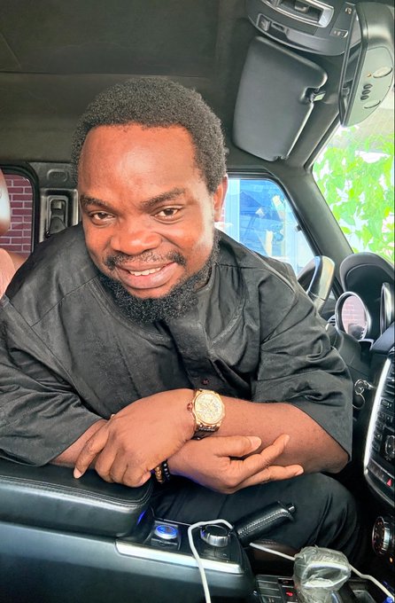 A man sits in the driver's seat of a car, smiling at the camera while wearing a black shirt and a gold watch, with his arms resting on the center console. The image ties into the post's playful promise to grow out his hair until the cryptocurrency token ($TON/$GRAM) breaks its all-time high of $8.235, currently trading at $1.824.