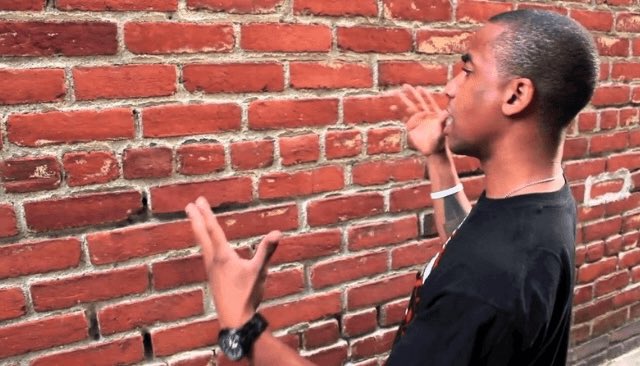 A man gestures towards a brick wall, symbolizing the need for the US Senate to pass the crypto Clarity Act. This image relates to the news that Franklin Templeton, an asset manager with $1.8 trillion in assets, is urging the Senate to pass this legislation.