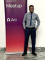 A man in a suit stands beside a red "Meetup" banner with the Arc logo, promoting engagement with the Arc ecosystem through regional chapters, local networking, and community meetups.