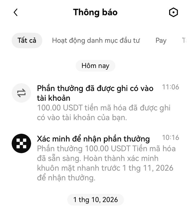 A Vietnamese notification screen ("Thông báo") showing a 100.00 USDT cryptocurrency reward has been credited to the account, with instructions to complete facial verification before November 1, 2026.