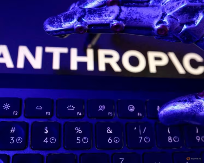 Close-up of a computer keyboard with a blue-lit screen displaying the word 'ANTHROPIC' in the background.