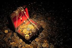 The image features an old wooden treasure chest filled with gold coins placed on a bed of gold coins. The chest has a red lock, adding a touch of color to the scene. The background appears dark, which contrasts with the bright gold of the coins and the chest itself. There is no text present in the image, but it seems to be related to the post about Zero-Knowledge Proofs.