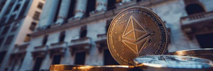 A golden Ethereum (ETH) cryptocurrency coin prominently displayed against a backdrop of city buildings and other coins.