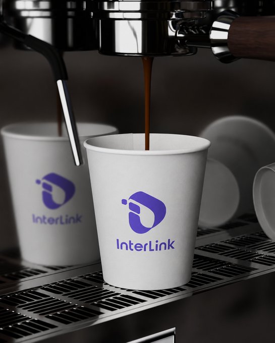 Coffee brews into a white cup branded with the purple "InterLink" logo, reflecting the post's "#InterLink" hashtag celebrating the brand. The scene ties directly to the ticker and #ITLG tag, suggesting a morning ritual for InterLink investors.