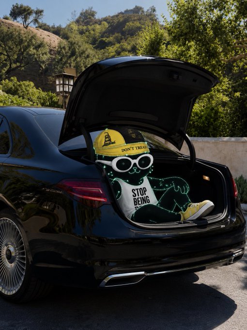 A black luxury sedan has its trunk open, revealing a 3D character wearing a 'DON'T TREAD' cap and a 'STOP BEING' shirt.