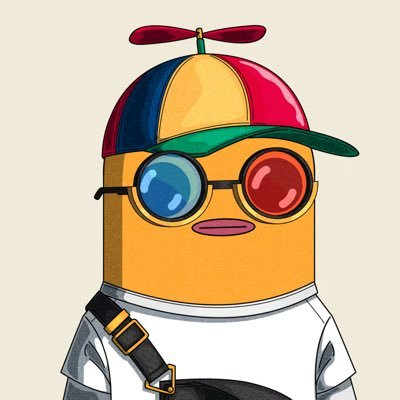 A cartoon character resembling a yellow cylindrical figure wearing 3D glasses (one blue, one red lens), a colorful propeller cap, white shirt, and a messenger bag strap.