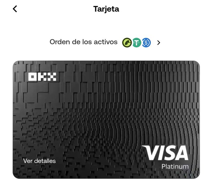 A screenshot of a digital wallet interface in Spanish showing a black "OKX" Visa Platinum card under the heading "Tarjeta", with options to sort assets by "C", "T", and "$" icons.
