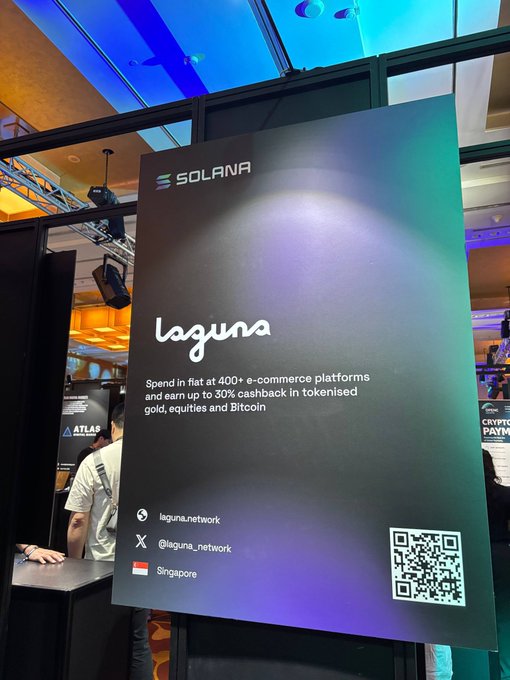 A Solana promotional poster for "laguna" displayed at an event advertises cashback rewards, featuring a Singapore location tag and QR code.