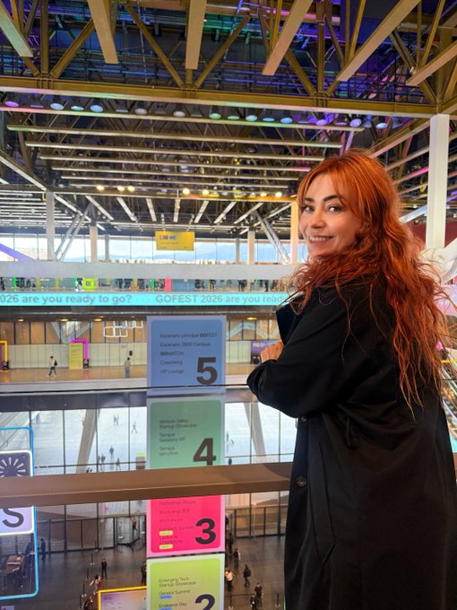 I’m at #GoFest2026 in Bogotá, connecting with startups across sectors including fintech, web3, and AI. Behind me, venue signs show levels 2–5, with signage reading “Elimina estrés en GO FEST” and “Marketplace.”