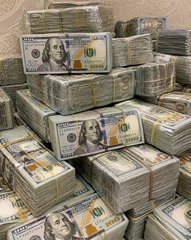 A large pile of banded stacks of US one hundred dollar bills.