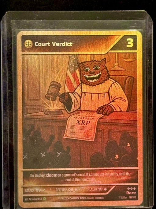 A holographic trading card titled 'Court Verdict' from FuzZy Cards 2026 Genesis Collection, depicting a grinning feline judge holding a gavel over a document labeled 'IN FAVOR OF XRP', with stats Attack 09, Defense 08, Health 10, and a rarity of 19/69.