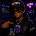 A person wearing a black hoodie, sunglasses, and a cap, accessorized with multiple silver chains and pendants, posing while pointing at themselves in a dimly lit venue.