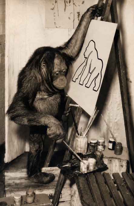 A vintage sepia photograph shows an orangutan standing before an easel, holding a brush and seemingly painting an outline of a gorilla on the canvas. The image humorously ties to the caption, suggesting the ape is taking a break from market chaos to "paint the charts" of the $APE stock.