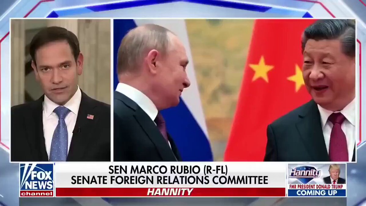 The image shows a news segment featuring two men dressed in suits having a conversation with each other, while a third man wearing a red tie stands behind them. The background of the scene includes a flag from Russia and China, as well as the text "sen Marco Rubio (R-FLI) - Senate Foreign Relations Committee". The image also contains the words "FATALITY" and "MAJORITY", which may be related to the ongoing political discussions or events.