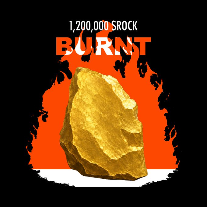 A graphic showing a large golden rock surrounded by flames with the text "1,200,000 $ROCK BURNT" above it.