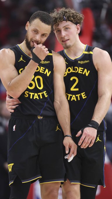 Stephen Curry (#30) and Brandin Podziemski (#2) of the Golden State Warriors share a moment on the court, representing two key members of the team's projected starting five for the upcoming season.