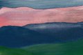 A blurry image showing a dark landscape with what appears to be a faint pink/red glow on the horizon.