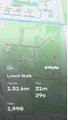 A blurry, low-resolution screenshot showing partially legible text including 'Lunch Walk', '2.51 km', and '1,998' with greenish hues.