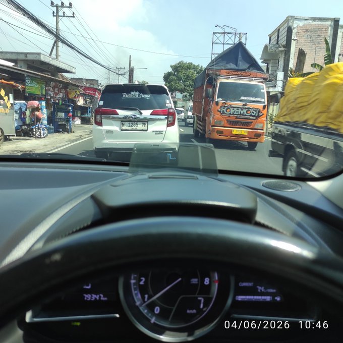 A driver's perspective of a car on the road, including traffic and a truck with orange and yellow accents. The image also features the text "GM fam, good systems usually remove friction: @NomismaNetwork Turning activity into something more meaningful than points @River4fun With $RIVER feels tied to real activity @quipnetwork PoUW is rethinking what networks should reward @TheARCTERMINAL @wallchain I". This image appears to be a combination of the driver's viewpoint and the post description, showcasing some interesting aspects of the road scene.