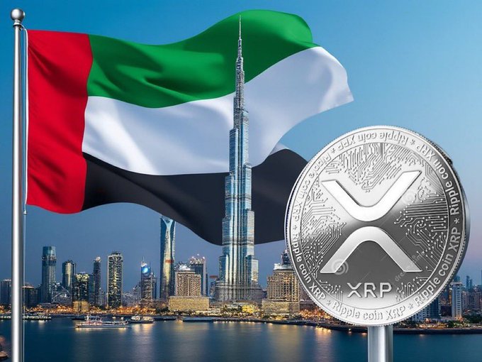 The United Arab Emirates flag waves in front of the Dubai skyline featuring the Burj Khalifa, with a large silver 'Ripple XRP' coin displayed prominently in the foreground.