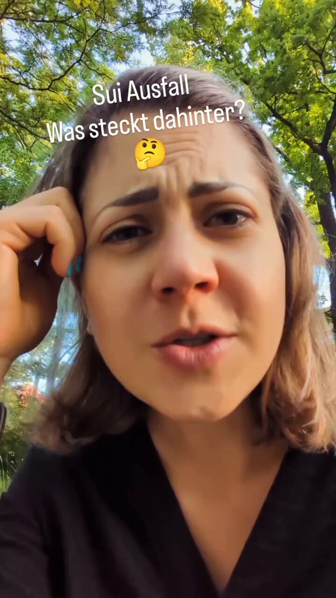 The image features a woman with blonde hair, wearing a black shirt, who has her hand on her head as if she's deep in thought or pondering over something. The background of the photo includes trees, suggesting that they might be outdoors. The caption provided about the sui:native outage and its online interview for tomorrow is related to this image because it shows the woman contemplating a topic while surrounded by nature.