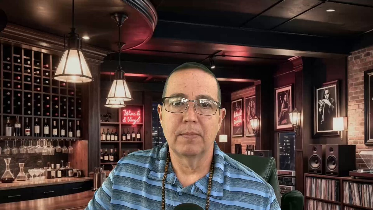 The image features a man wearing glasses sitting at a bar, with several bottles of wine behind him. The man appears to be talking into a microphone or recording device, possibly discussing something related to XRP (XRP Secret Infinite).