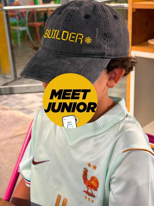 A child wearing a black 'BUILDOER' cap and a light green French national team jersey with the rooster logo, with a yellow 'MEET JUNIOR' circle overlay.