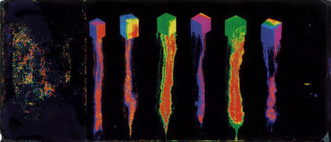 An abstract digital artwork featuring colorful cubes floating above streaks of red, orange, yellow, and blue against a black background, with a pixelated noise pattern on the left.