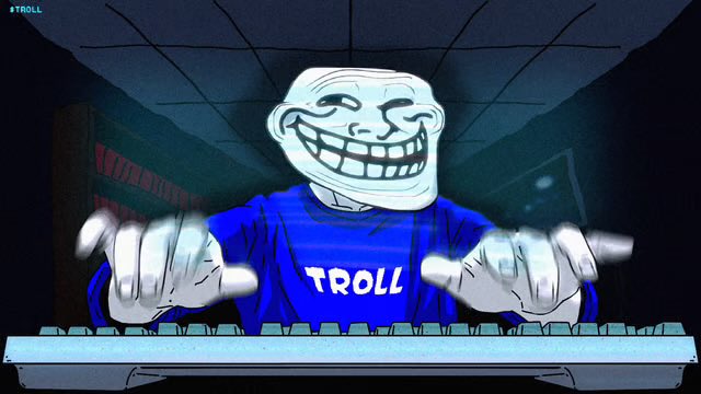 An animated troll face character wearing a blue shirt labeled "TROLL" plays a keyboard, with a "TROLL" watermark in the top left corner.