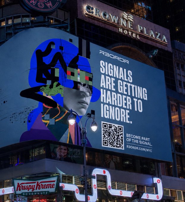 A nighttime photo of a large billboard in a city (near Crowne Plaza and Krispy Kreme signs) displaying digital art and the text 'R3CORD', 'SIGNALS ARE GETTING HARDER TO IGNORE', and 'BECOME PART OF THE SIGNAL. R3ORDR.COM/NYC' with a QR code.
