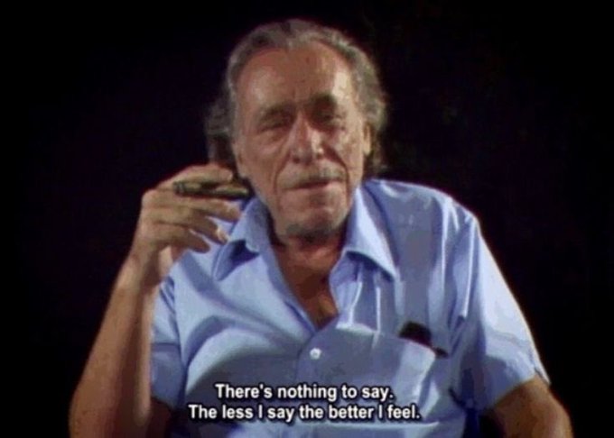 A photograph of actor David Carradine speaking in an interview, holding a cigar, with the subtitle 'There's nothing to say. The less I say the better I feel.'