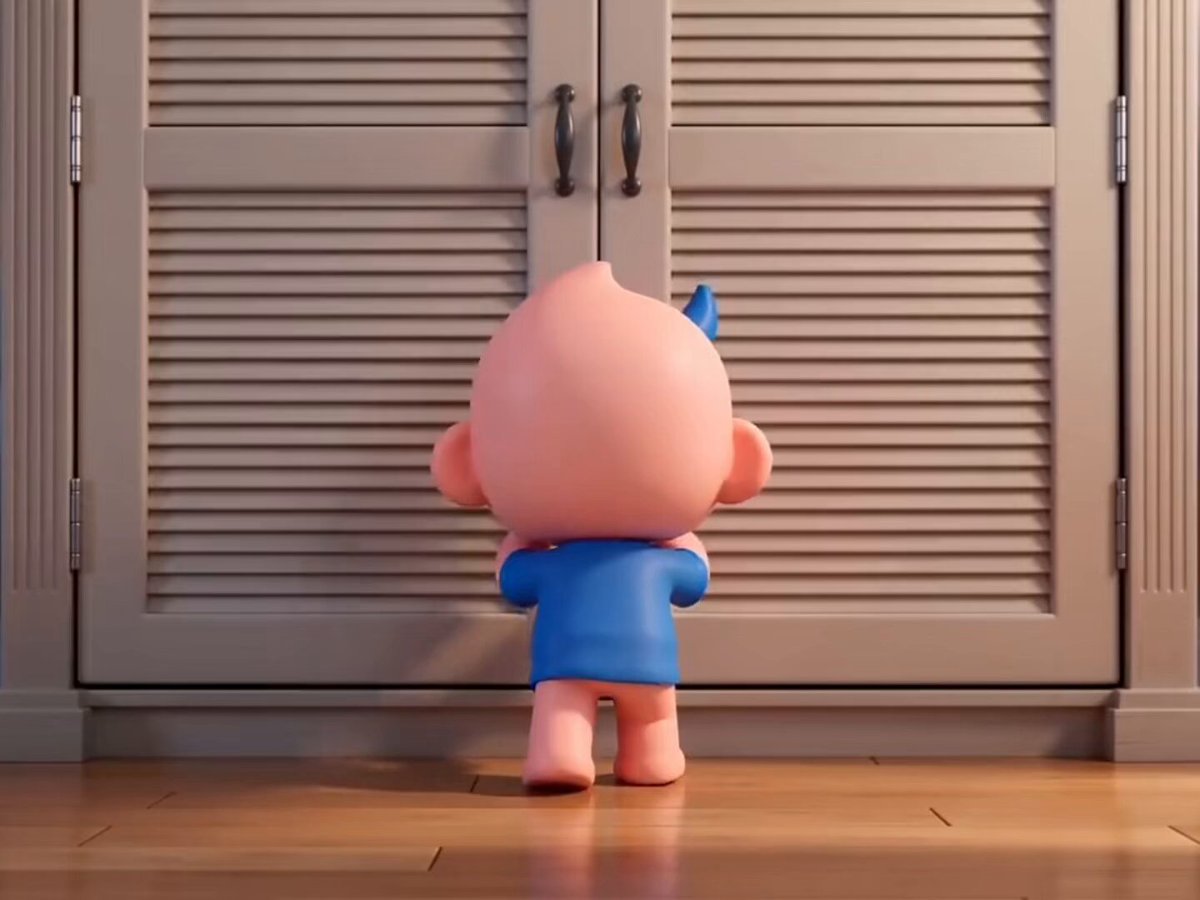 A 3D-rendered cartoon character with a small blue mohawk and blue top stands pantless from behind, facing closed louvered closet doors—visually illustrating the character's plea for help designing pants to complete its outfit.
