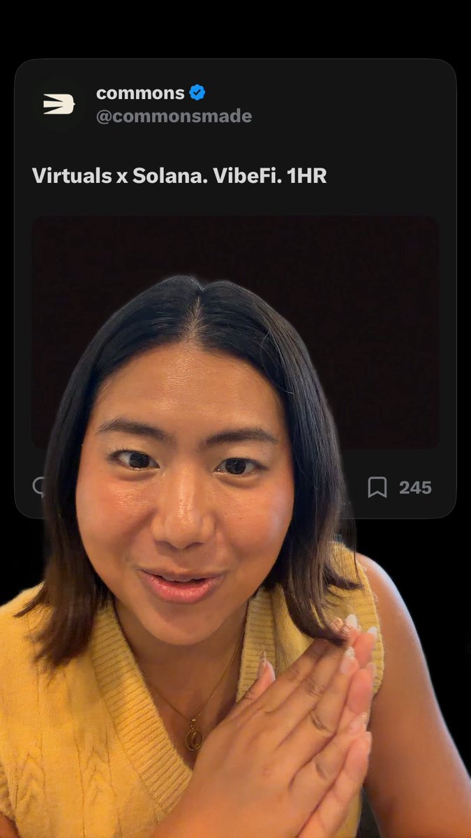A young woman in a yellow sweater smiles and clasps her hands together while a tweet from @commonsmade reading 'Virtuals x Solana. VibeFi. 1HR' is overlaid behind her.