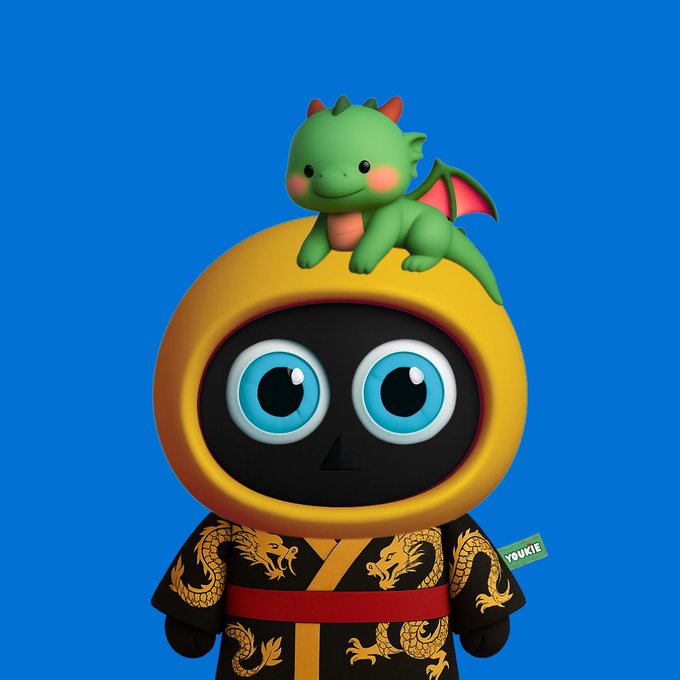 A 3D-rendered figure of a black-faced character with large blue eyes wearing a yellow hood and a black robe with gold dragon patterns, with a cute green dragon sitting on top of its head; a green 'YOUKIE' tag is visible.